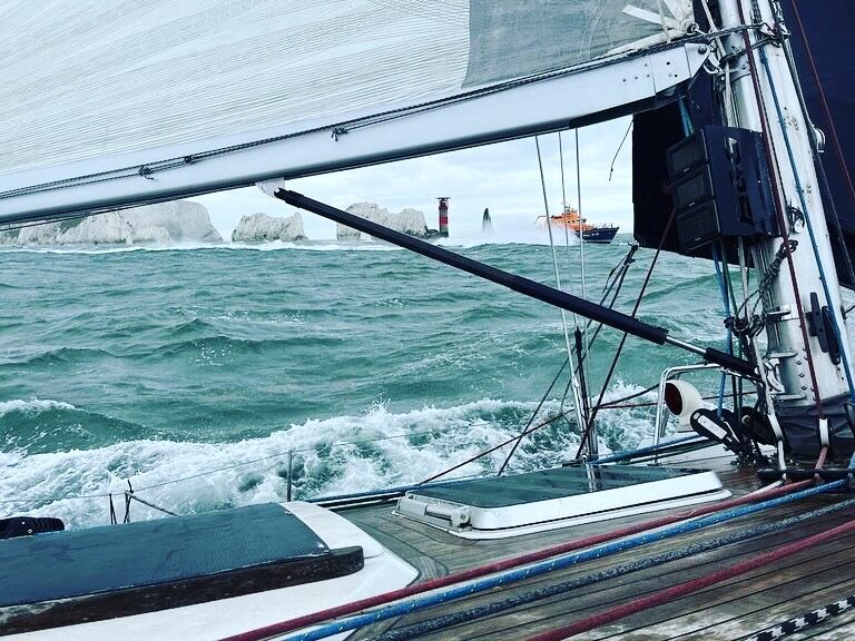 Racing past the Needles lighthouse at the western tip of the Isle of Wight
